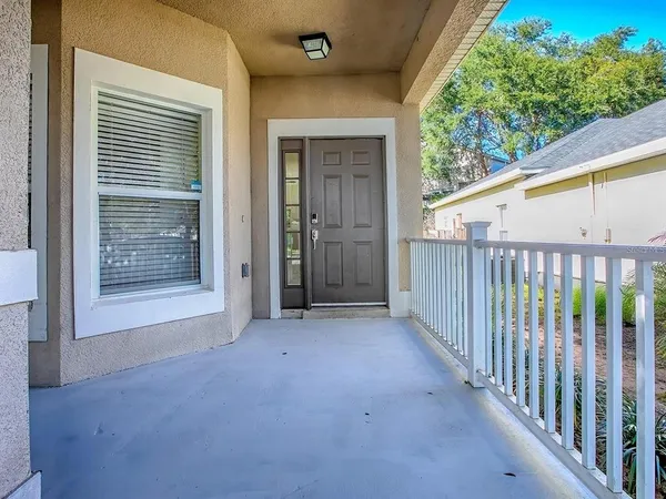 a view of a porch with wooden floor and fence