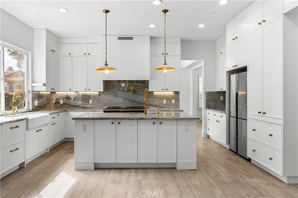 a view of kitchen with refrigerator sink and wooden floor