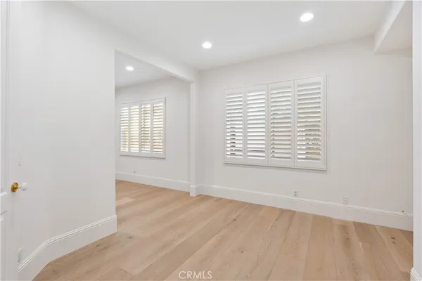 a view of staircase with railing and white walls
