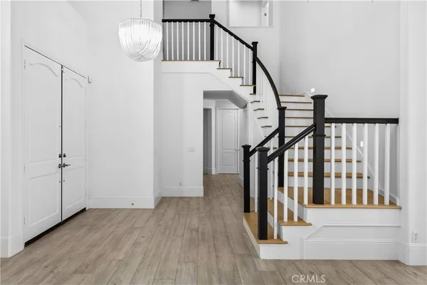 an empty room with a window and wooden floor