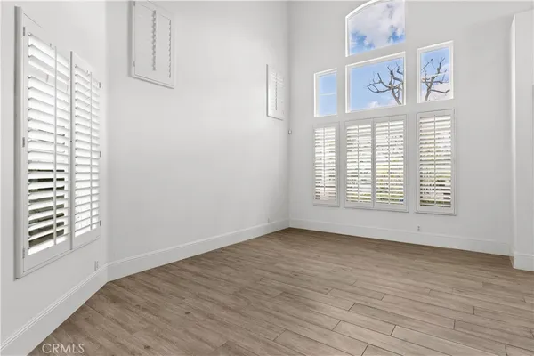a kitchen with stainless steel appliances granite countertop a sink a window and chairs
