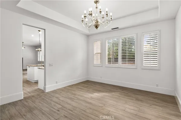 a kitchen with stainless steel appliances granite countertop a stove a oven and a white cabinets
