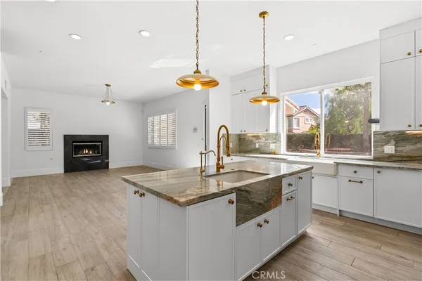 a kitchen with stainless steel appliances granite countertop a refrigerator a sink and a stove