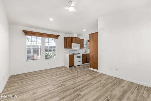 a view of a kitchen with wooden floor and a window