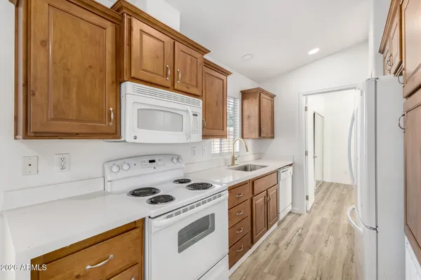 a kitchen with a sink stove and cabinets