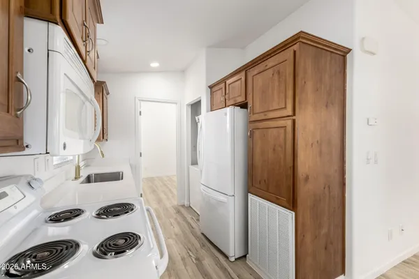 a bathroom with a sink a mirror a washer and dryer