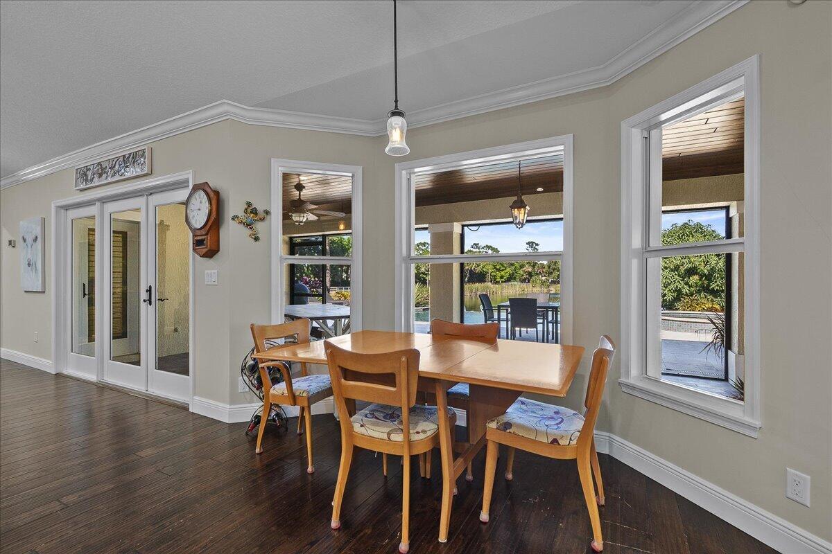 10975 Randolph Siding Road Jupiter, FL 33478 - Photo 31 of 97 a view of a dining room with furniture window and wooden floor