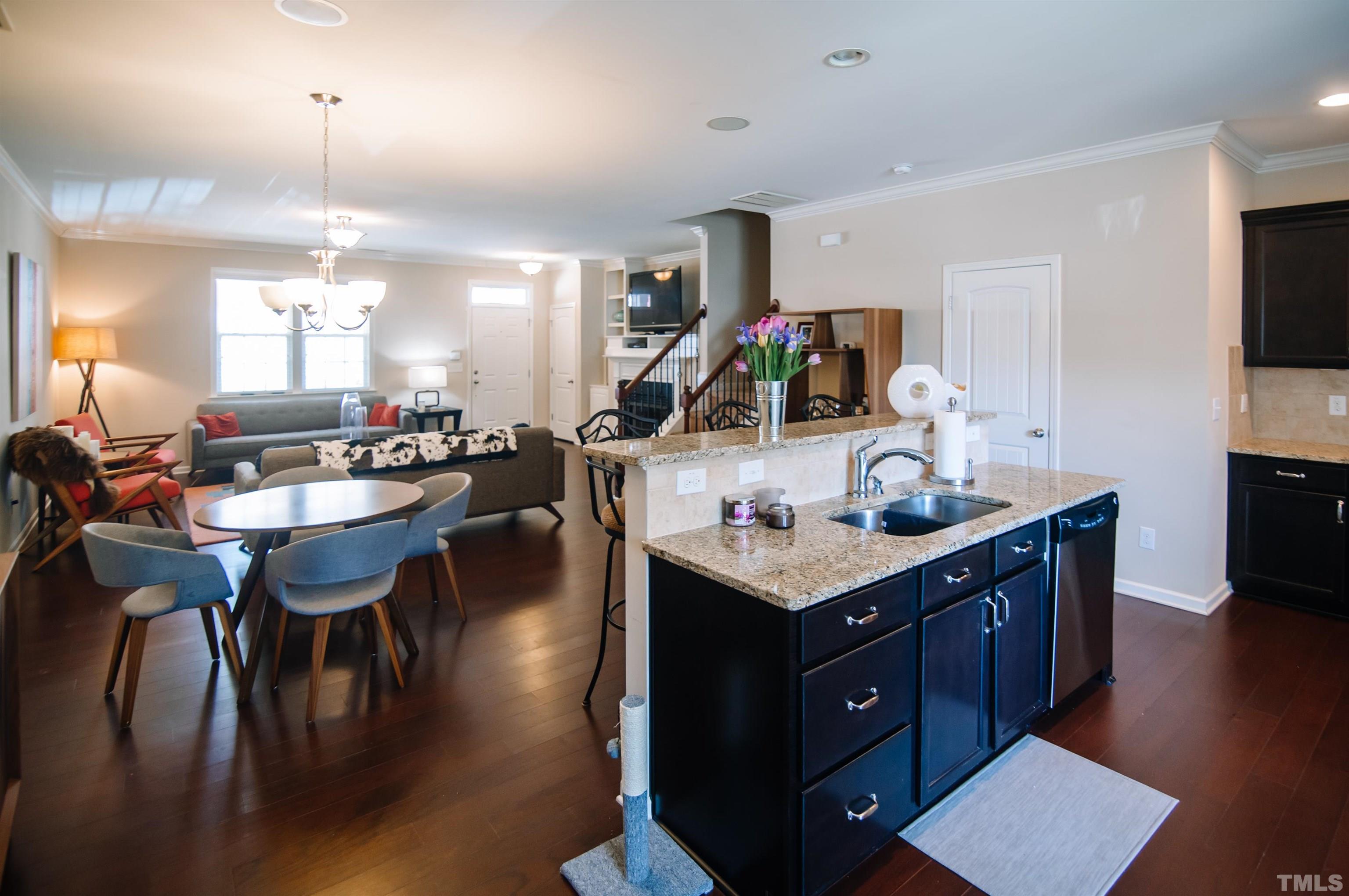 1308 Still Monument Way Raleigh, NC 27603 - Photo 8 of 21 a kitchen with a table chairs and flat screen tv
