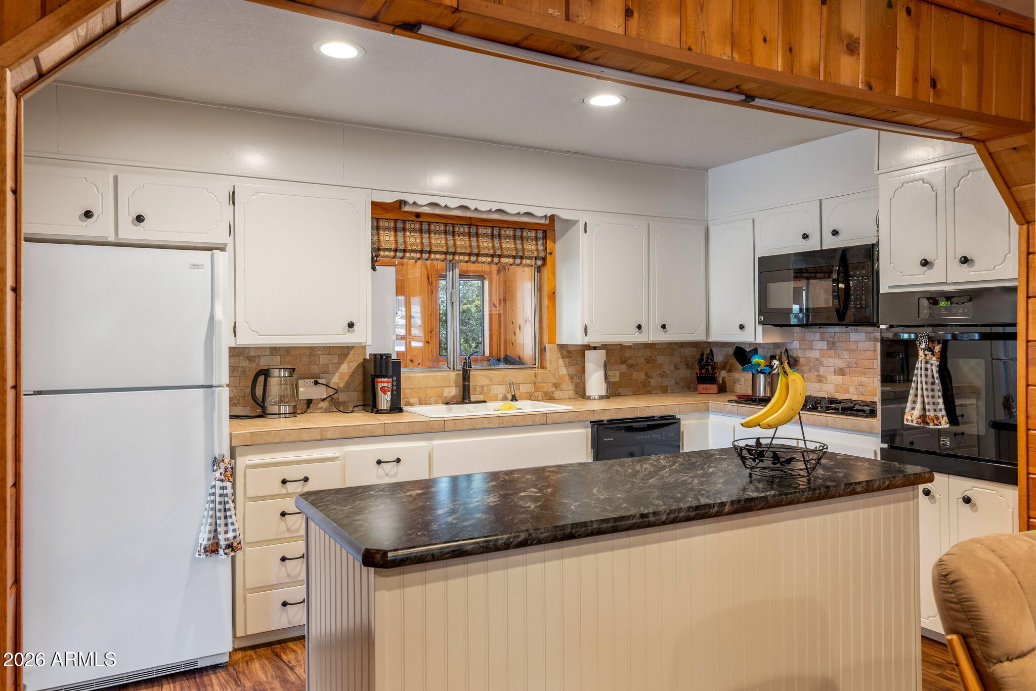 3384 Turkey Run Overgaard, AZ 85933 - Photo 11 of 37 a kitchen with granite countertop a refrigerator a stove a sink a counter space and cabinets
