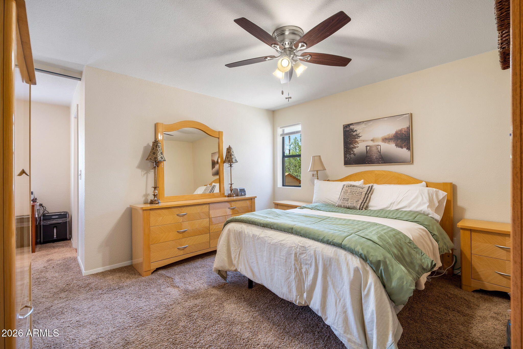 3384 Turkey Run Overgaard, AZ 85933 - Photo 21 of 37 a bedroom with a bed and a chandelier