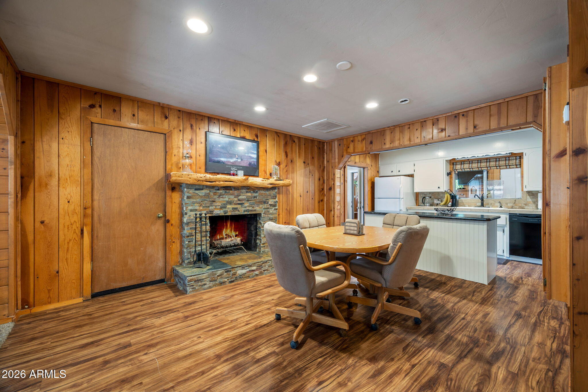 3384 Turkey Run Overgaard, AZ 85933 - Photo 9 of 37 a view of a dining room with furniture and a fireplace