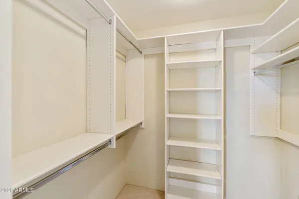 an empty room with closet and windows