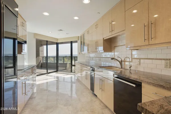 a view of an empty room with closet and a window