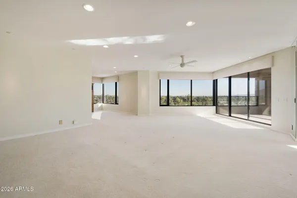 a living room with furniture a table and a large window