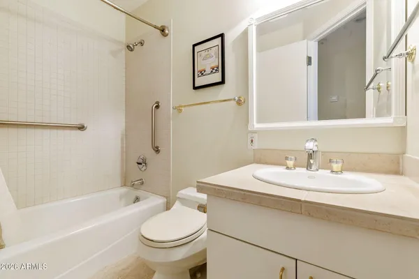 a view of an empty room with window and closet area