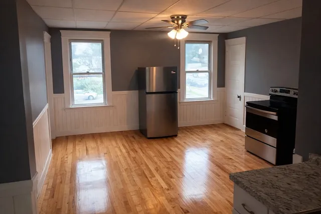 a view of a livingroom with furniture window and wooden floor