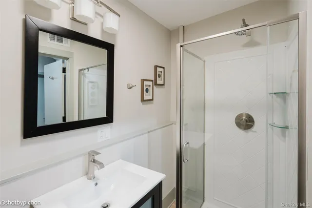 a bathroom with a toilet sink vanity and mirror