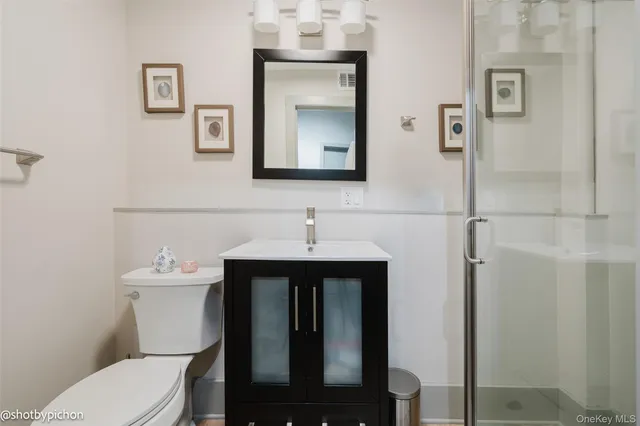 a bedroom with a bed and cabinet