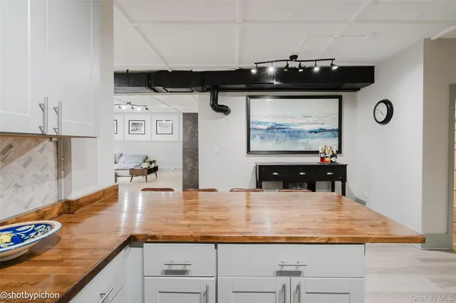 a kitchen with granite countertop a sink and cabinets