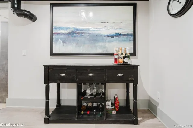 a table with wine bottles and glass windows