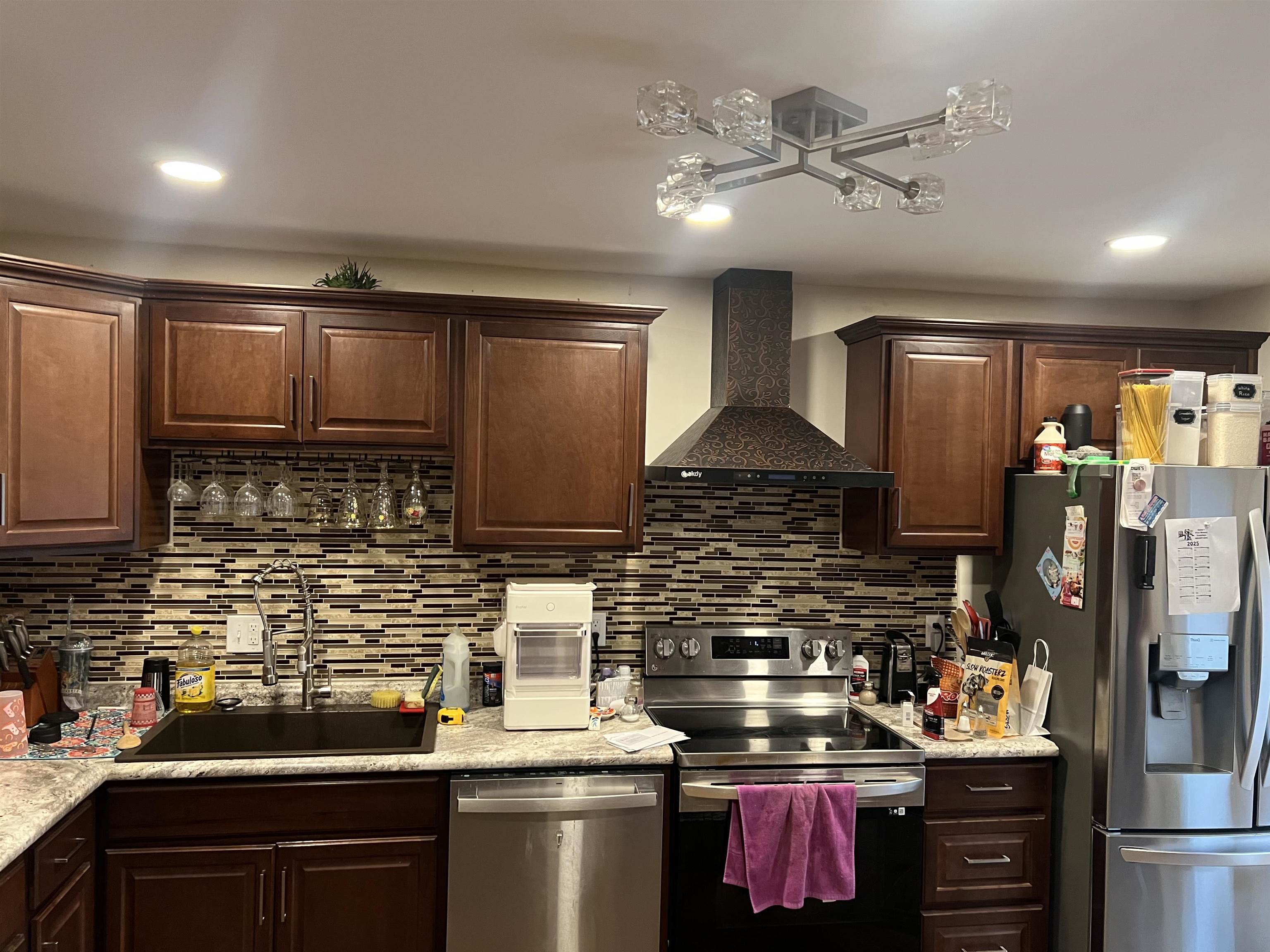 a kitchen with stainless steel appliances granite countertop a stove sink and cabinets
