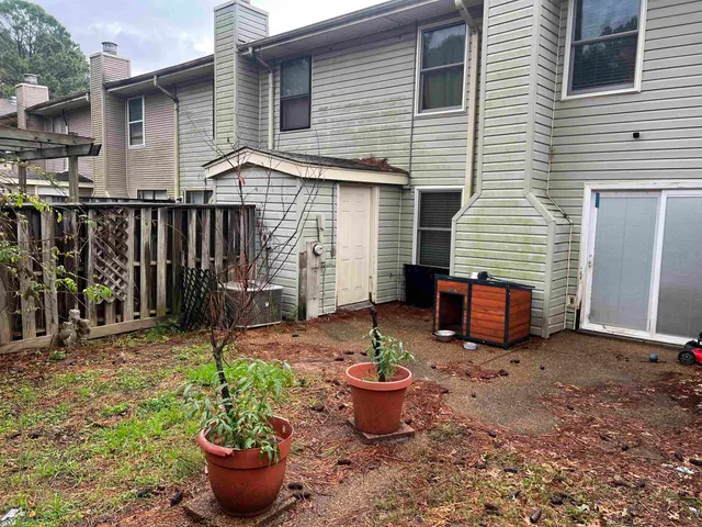 a view of a backyard with plants and patio