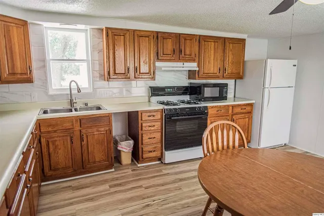 a kitchen with a stove a sink and a refrigerator
