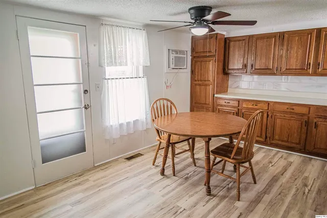 a dining room with wooden floor and a window
