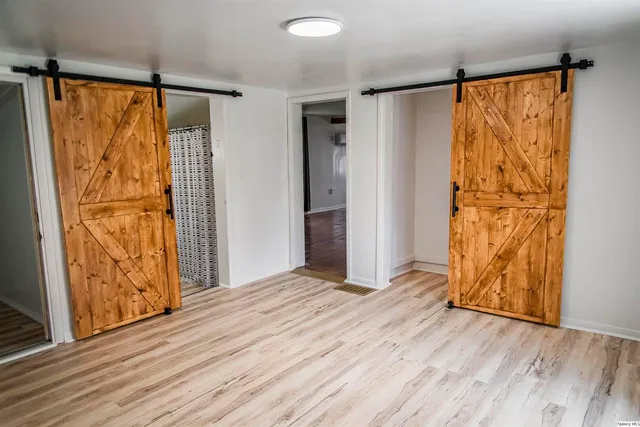 a view of walk in closet with wooden floor
