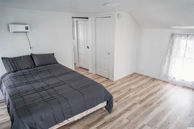 a bedroom with a bed and a window