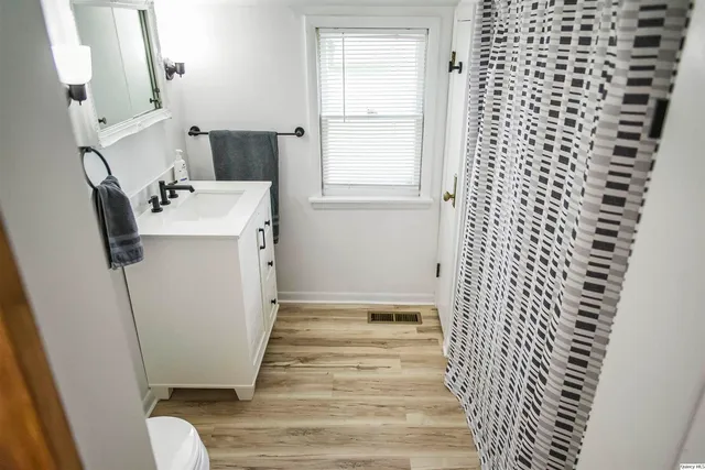 a view of a bathroom with sink and mirror
