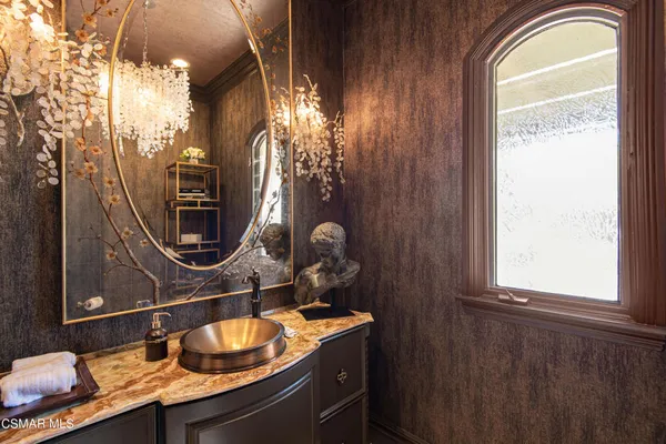 a bathroom with a granite countertop sink a mirror and shower