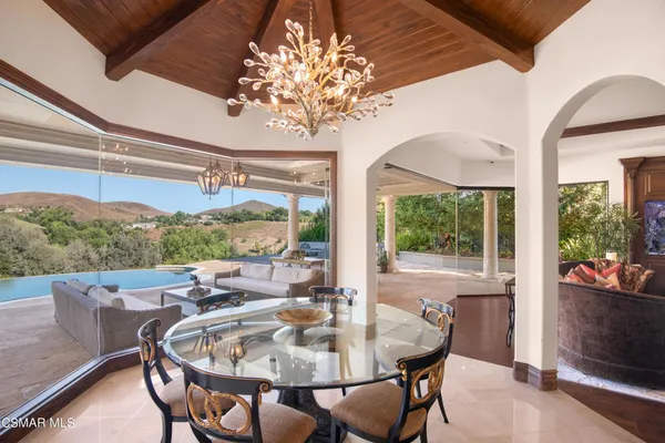a view of a dining room with furniture wooden floor and chandelier