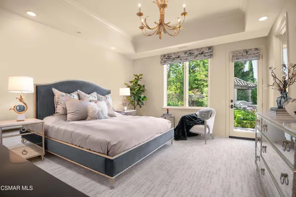 a bedroom with a bed gym equipment and a large window