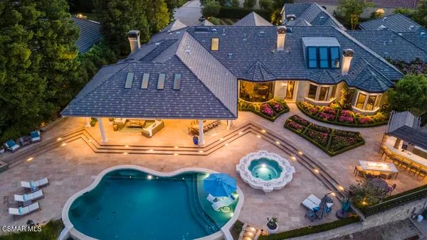 an aerial view of a house with a swimming pool