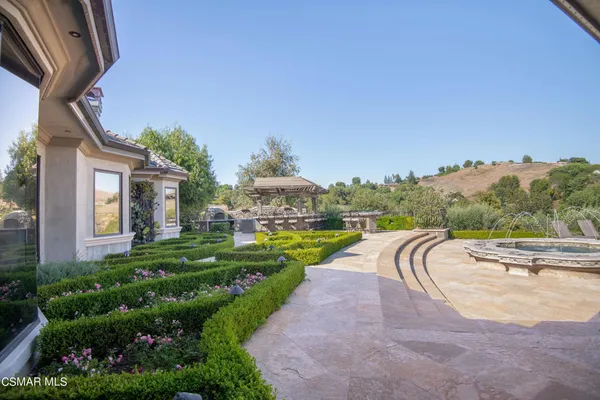 a swimming pool with outdoor seating and yard