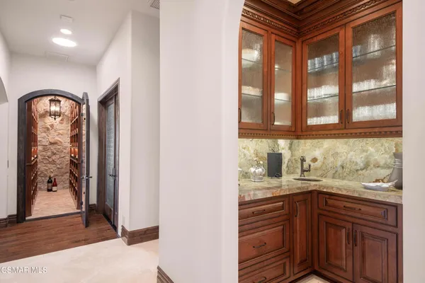 a bathroom with a sink a vanity and a large mirror