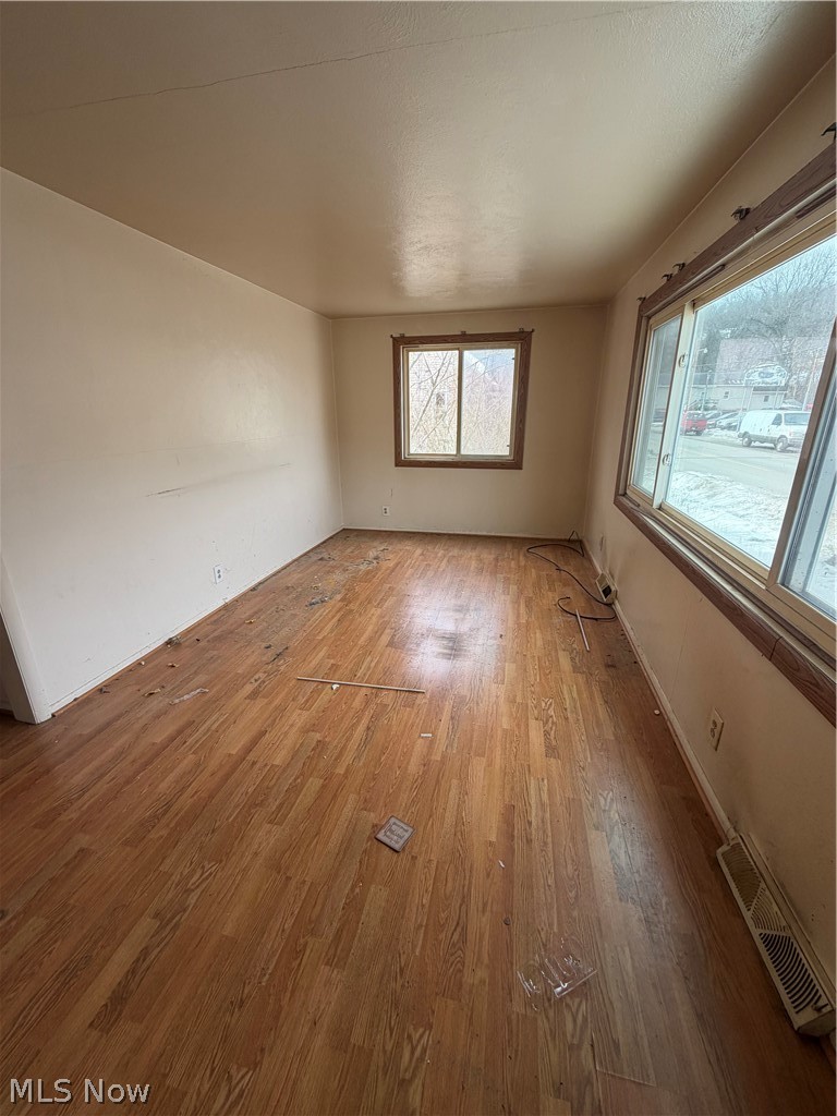55060 National Road Bridgeport, OH 43912 - Photo 2 of 14 Empty room featuring wood finished floors and baseboards