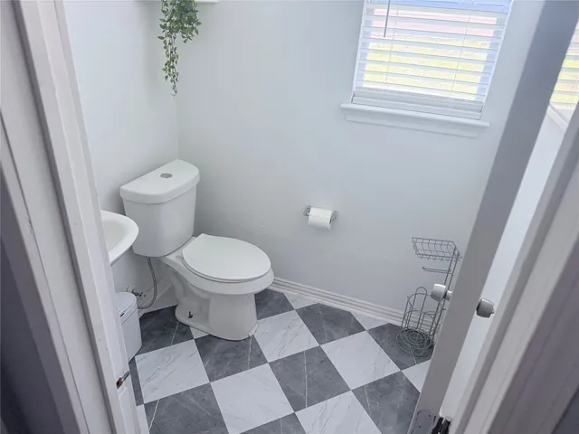 a white toilet sitting next to a bathroom sink
