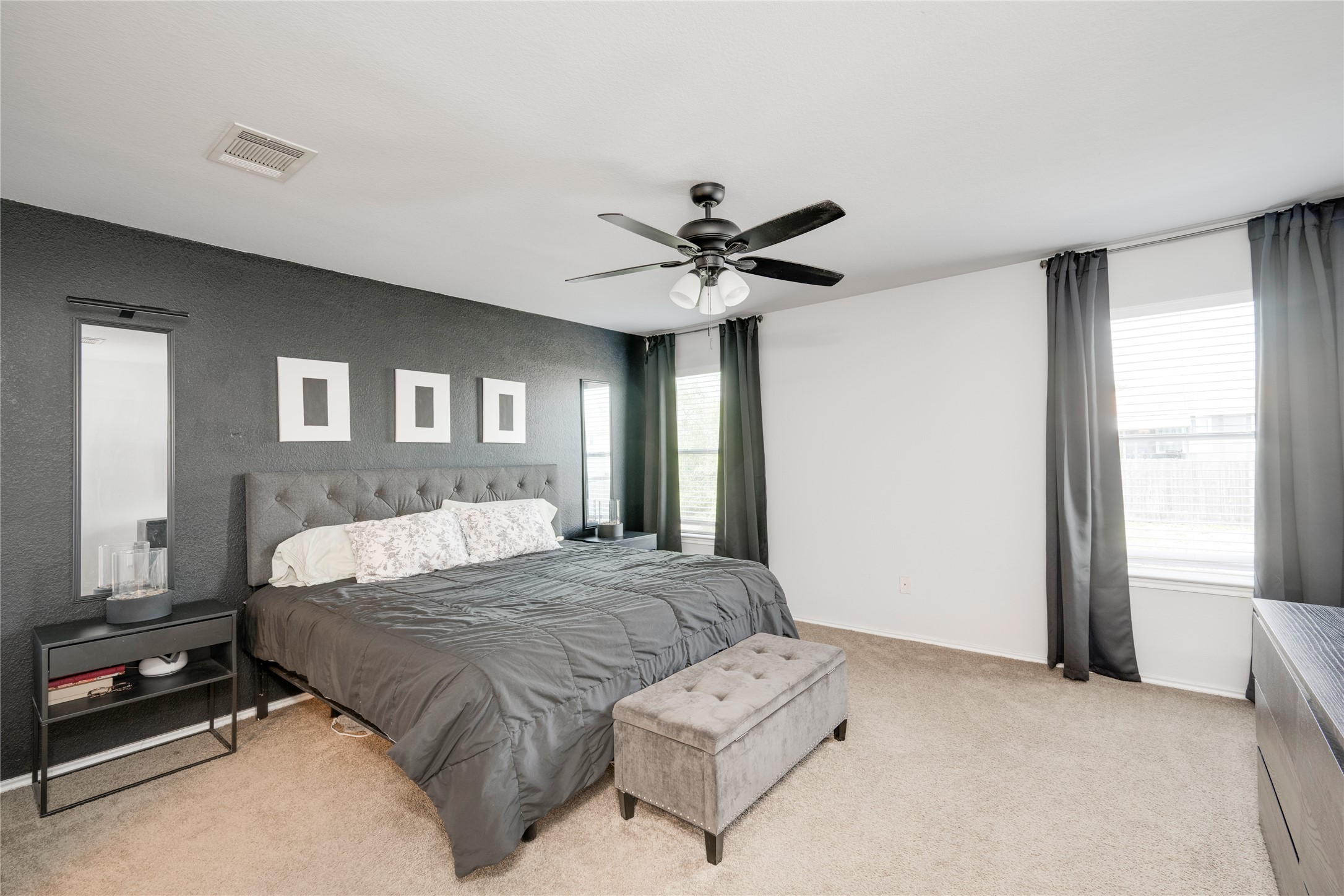 148 Buttercup Way Kyle, TX 78640 - Photo 18 of 40 Bedroom with light carpet, a ceiling fan, and baseboards