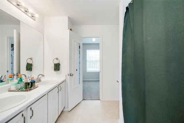 a bathroom with a sink double vanity and a mirror