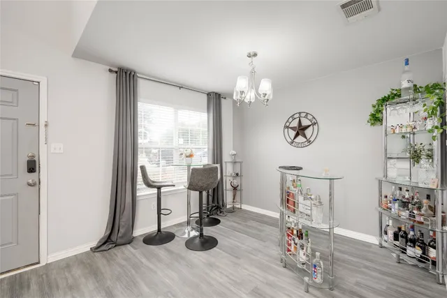 a view of a room with wooden floor and windows