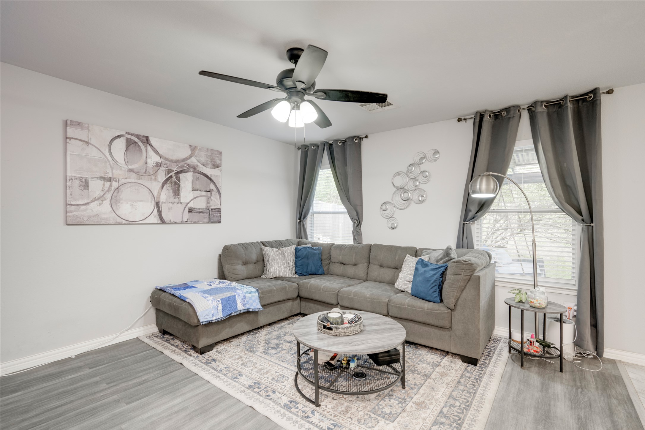148 Buttercup Way Kyle, TX 78640 - Photo 8 of 40 Living area with wood finished floors, baseboards, and a ceiling fan