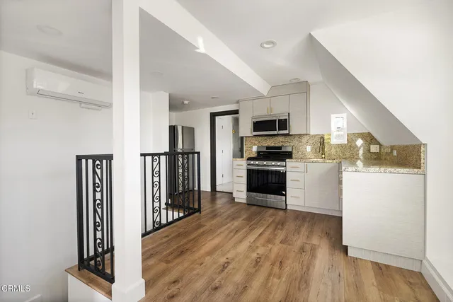 a kitchen with white cabinets stainless steel appliances and sink
