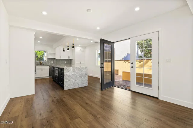 a view of a kitchen with furniture and wooden floor