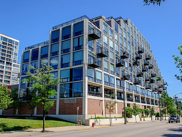 a view of a tall building next to a road
