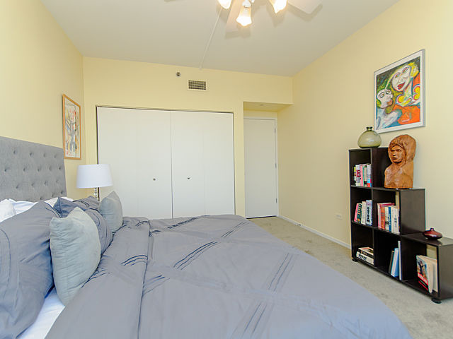 61 West 15th Street, Unit 607 Chicago, IL 60605 - Photo 14 of 23 a bedroom with a bed and a book shelf