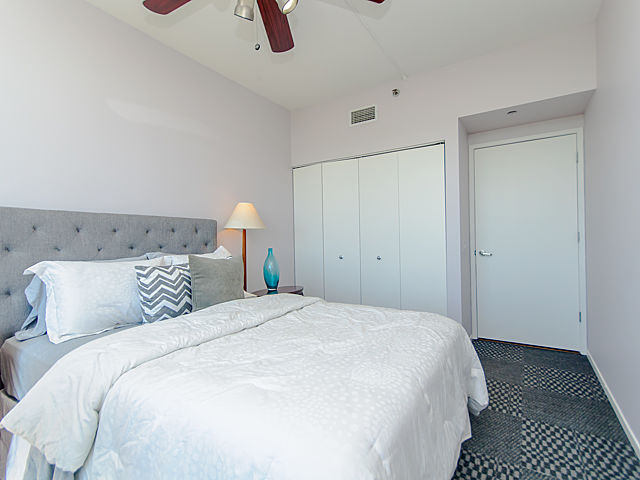 61 West 15th Street, Unit 607 Chicago, IL 60605 - Photo 16 of 23 a bedroom with a bed and a lamp