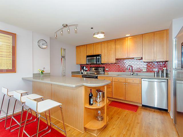 61 West 15th Street, Unit 607 Chicago, IL 60605 - Photo 2 of 23 a kitchen with stainless steel appliances granite countertop a stove and white cabinets
