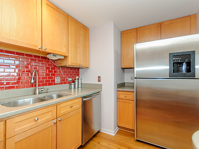 61 West 15th Street, Unit 607 Chicago, IL 60605 - Photo 5 of 23 a kitchen with stainless steel appliances granite countertop a sink and a refrigerator